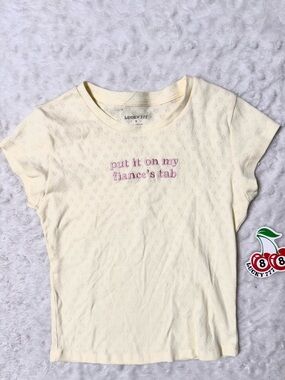 NWT- LUCKY 777 Embroidered “Put it on my Fiancés tab” Cream Baby Doll Tee